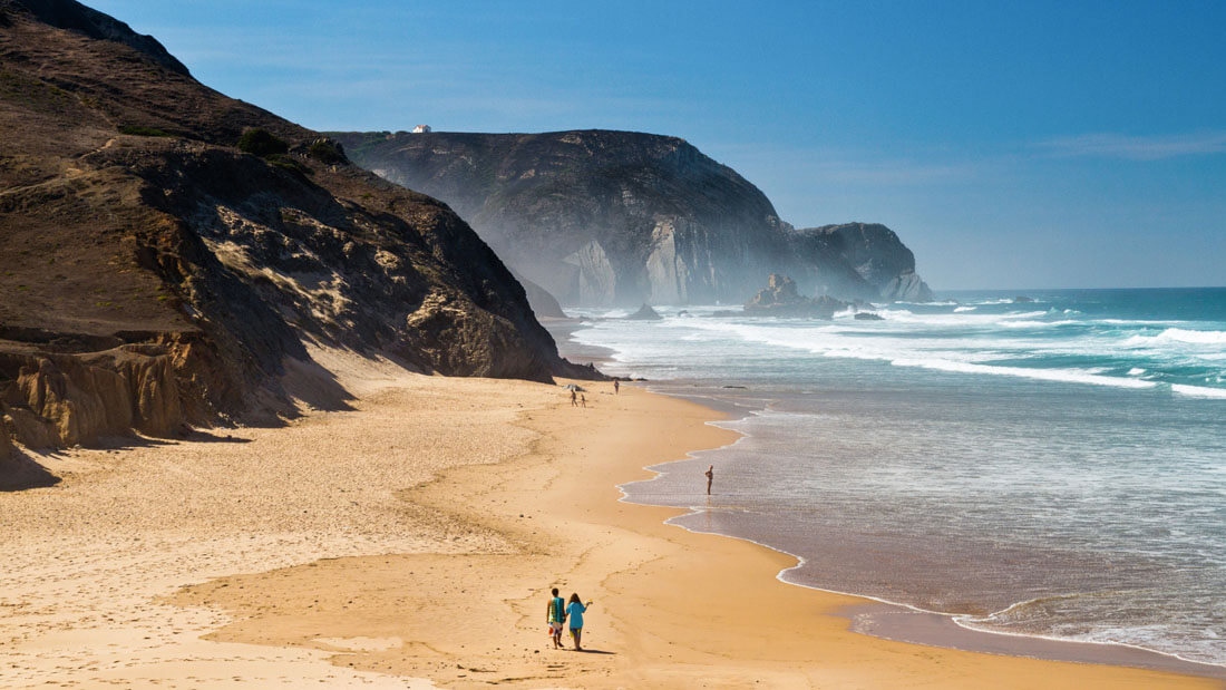 beach with waves and cliffs